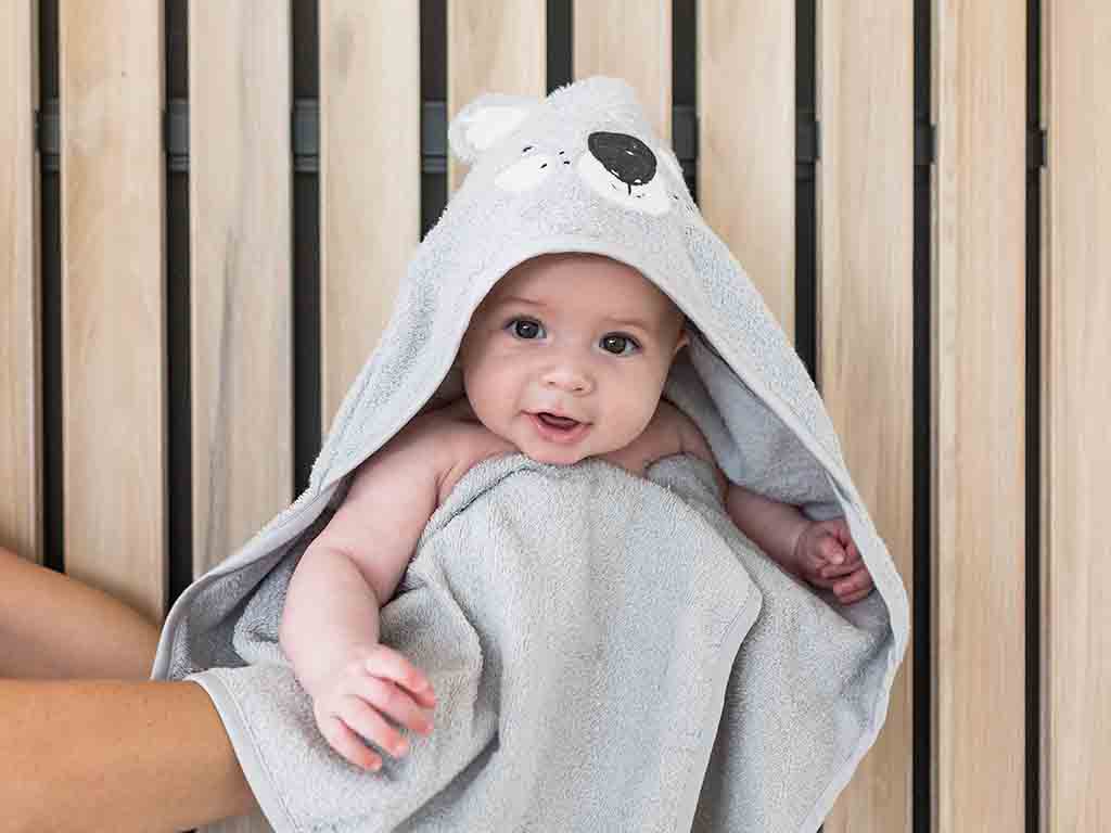 Baby in Mister Fly koala hooded towel