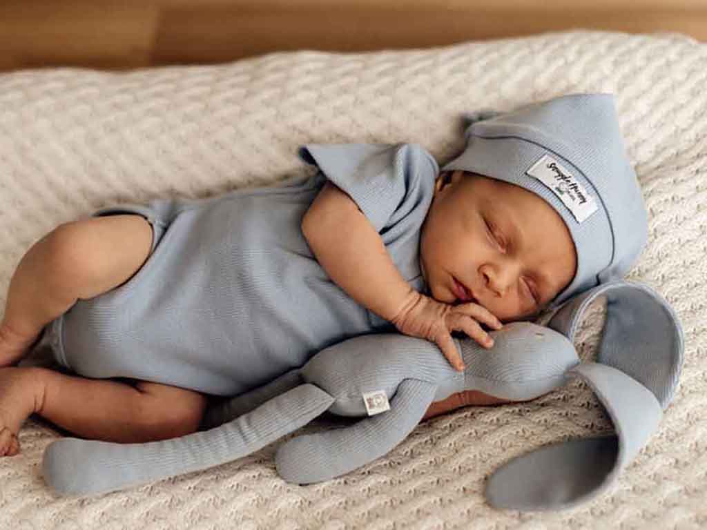 Baby cuddling with Snuggle Hunny bunny in dusty blue zen available at Young Willow