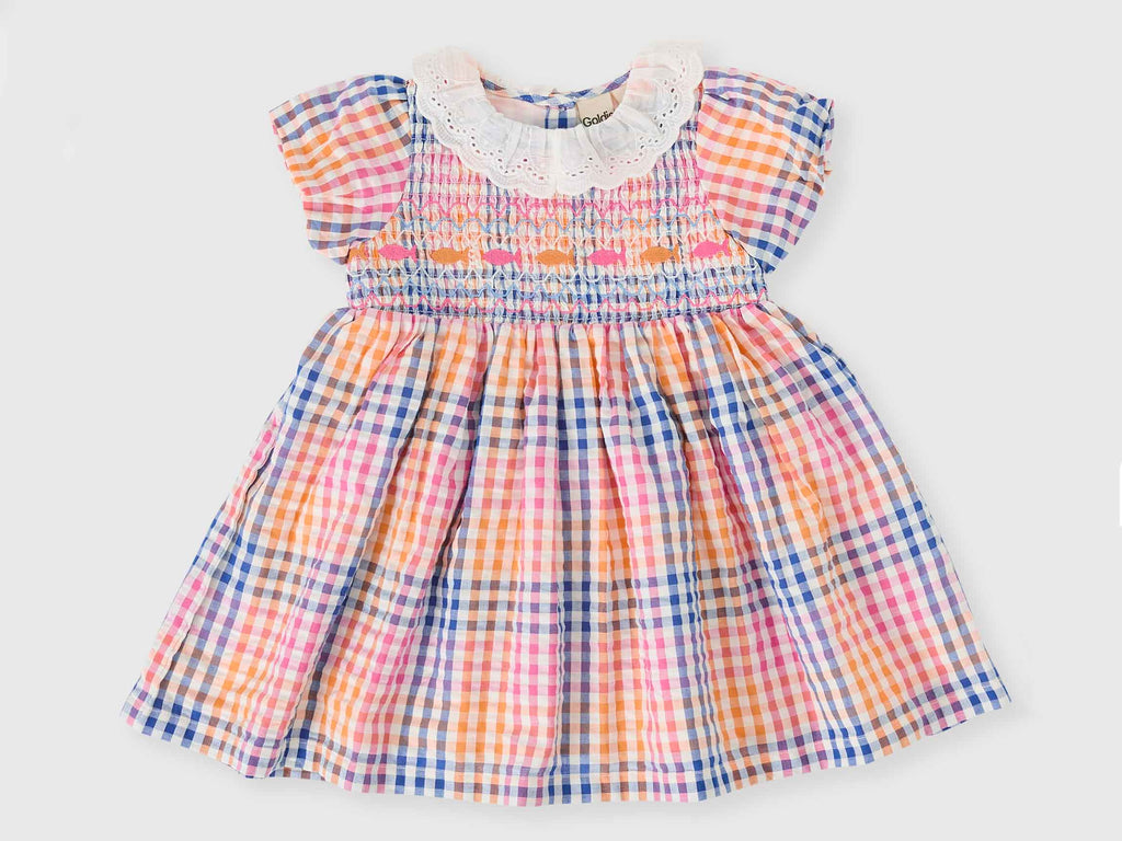 Colorful checkered dress with lace collar on a light gray background