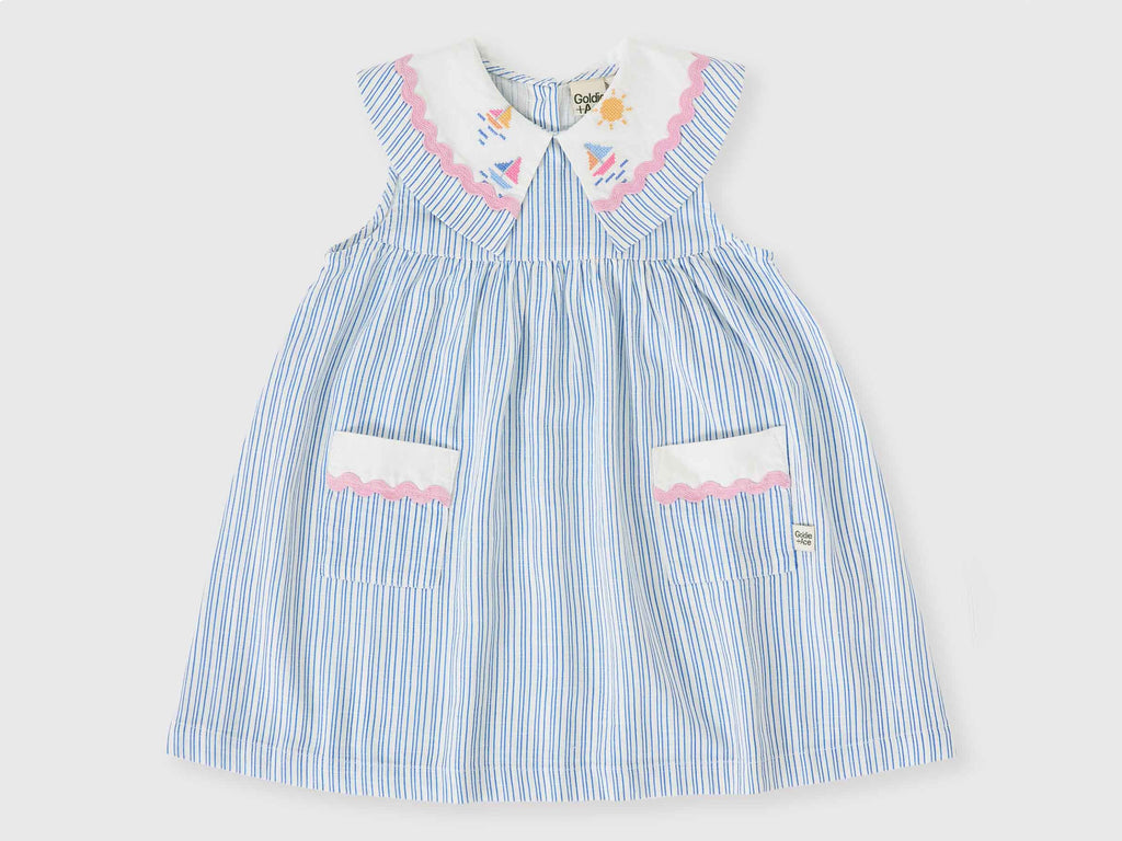 Blue striped dress with white collar and pink accents on a light gray background
