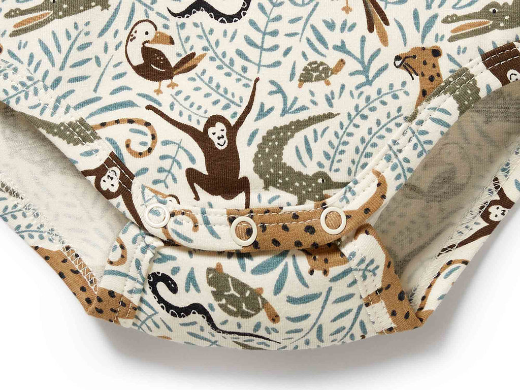 Patterned fabric with jungle animals and foliage on a white background