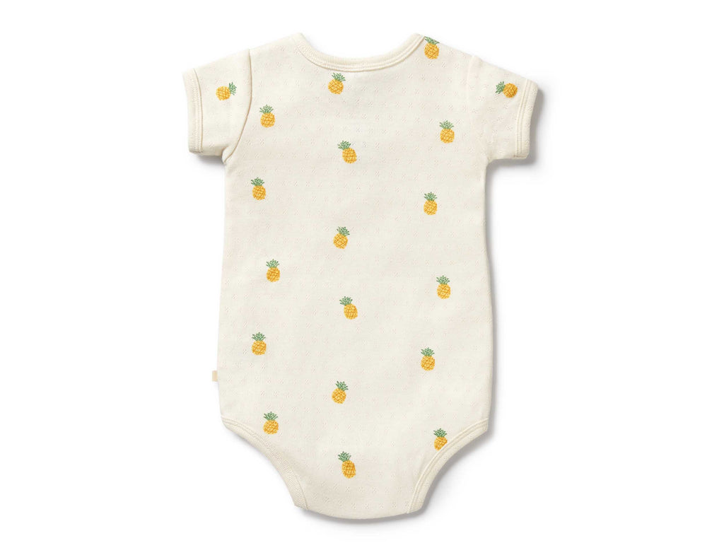 Baby onesie with pineapple pattern on a white background
