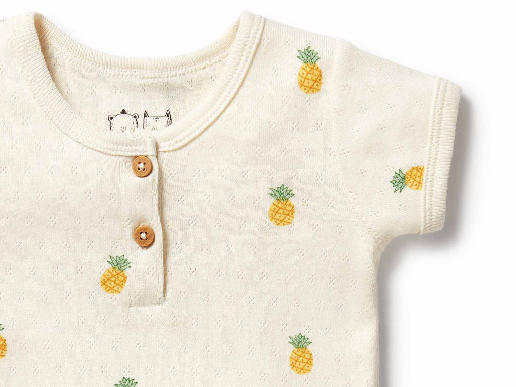 Baby onesie with pineapple patterns on a white background