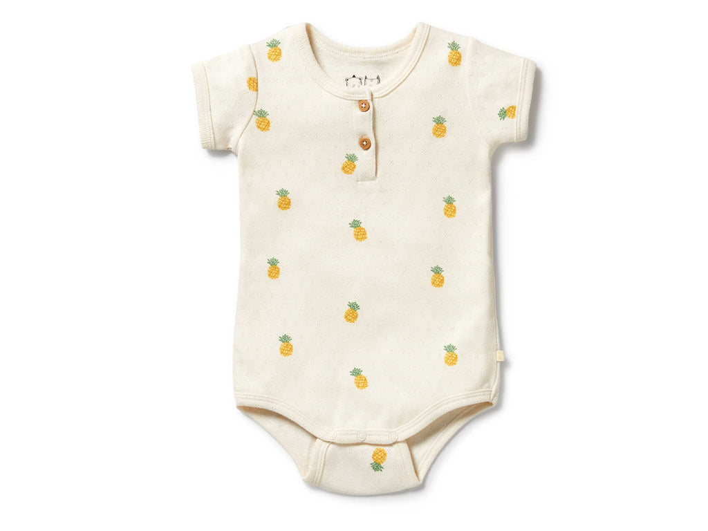 Baby onesie with pineapple pattern on a white background