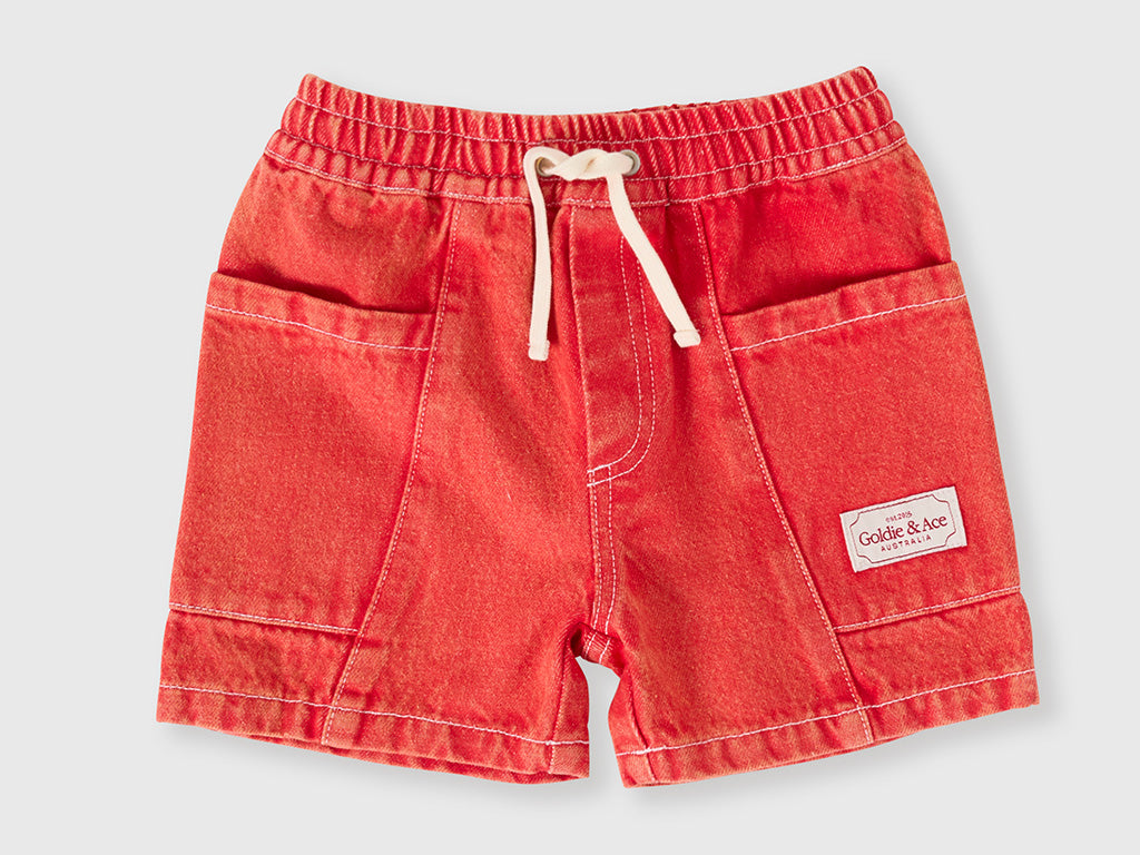 Red shorts with a drawstring on a light gray background
