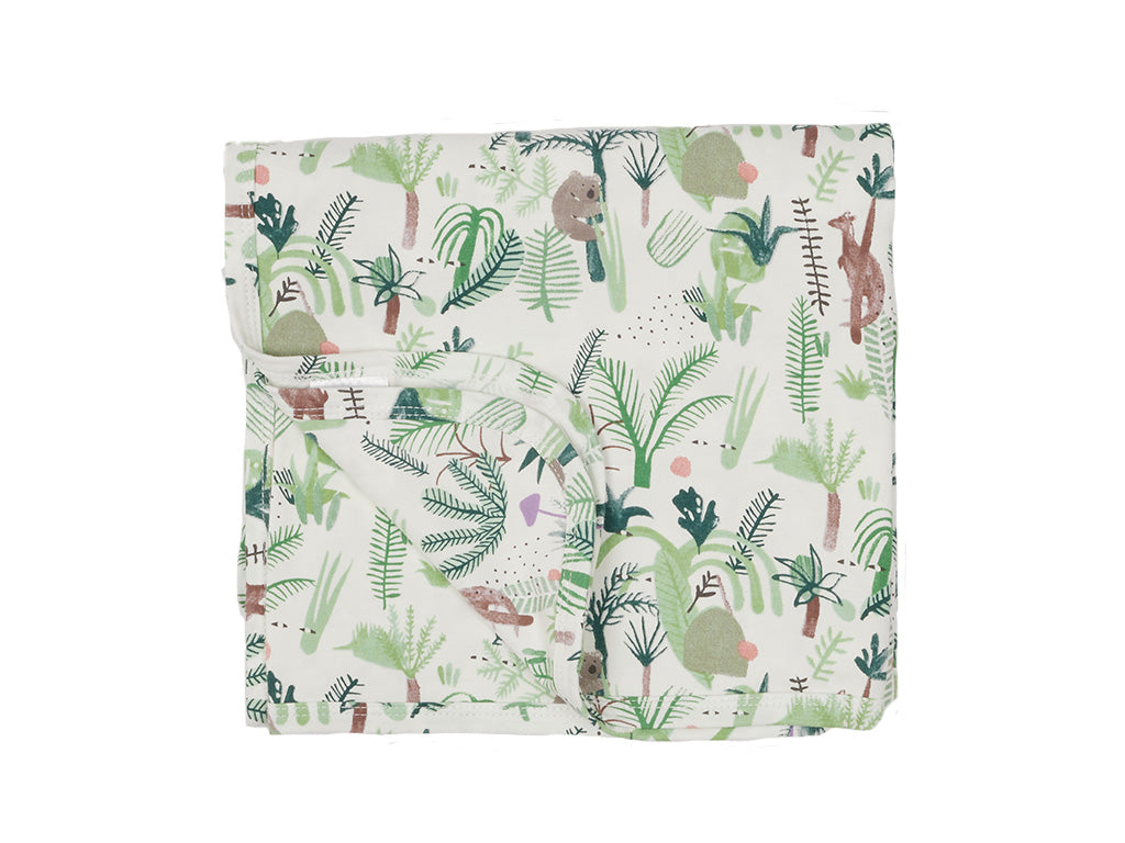 Folded fabric with a fern-themed pattern on a white background
