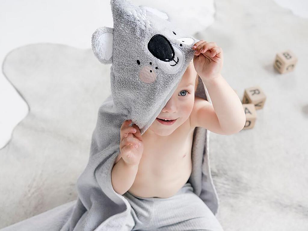 Child looking out of Mister Fly koala hooded towel