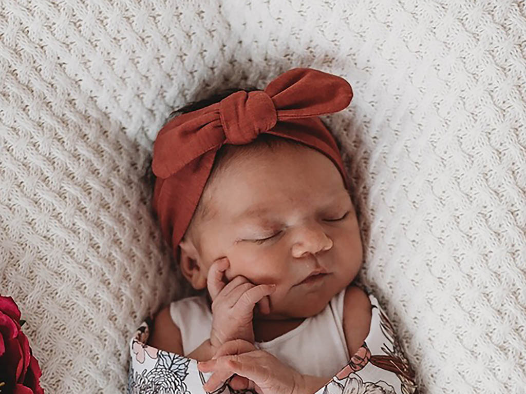 Snuggle Hunny Deep Rust headband on baby girl sleeping young willow