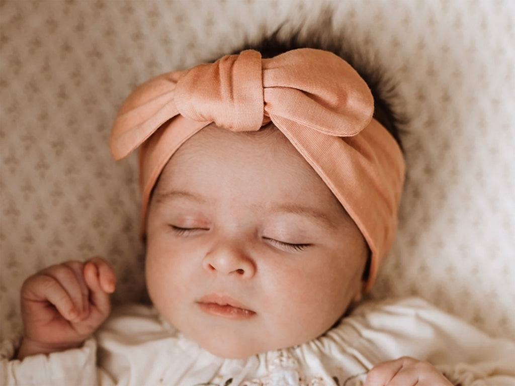snuggle hunny peach topknot headband on baby girl yong willow