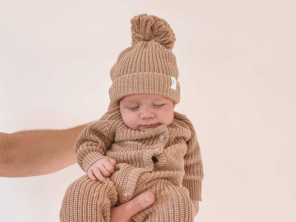 Ziggy Lou Chunk knit fawn romper on baby boy sleeping at Young Willow